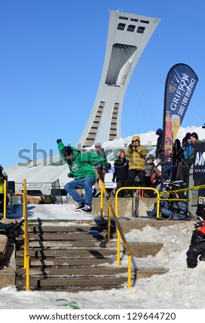 MONTREAL CANADA FEBRUARY 17: Unidentified participant in snowboarding at the Barbegazi Winter Extreme Sports Festival in front the Olympic Stadium on February 17 2013 in Montreal Canada