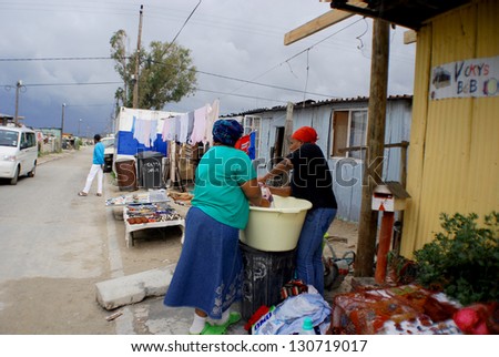 CAPE TOWN SOUTH AFRICA MAY 23: Women wash their clothes in Khayelitsha township on may 23 2007 in Cape Town South Africa It is reputed to be the largest and fastest growing township in South Africa