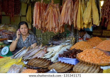KAMPONG THUM CAMBODIA MARCH 26: Woman sale dry sea food and fish on march 26 2013 in Kampong Thum Cambodia.