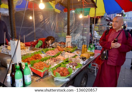 SEOUL SOUTH KOREA APRIL 6: Woman sells foods a the Namdaemun market on april 6 2013 in Seoul South Korea. Namdaemun Market, located in the center of Seoul, is the biggest traditional market in Korea
