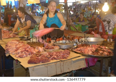 LUANG PRABANG LAOS APRIL 3: Woman sells raw meat at the central market on april 3 2013 in Luang Prabang Laos. Apparently when cooked, this stuff is smooth like tofu!
