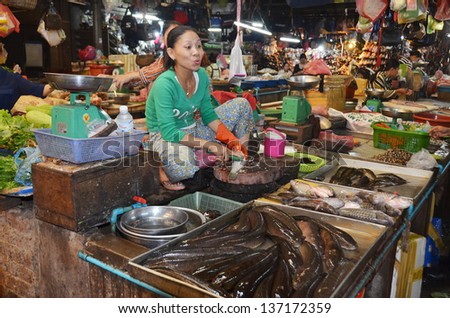 LUANG PRABANG LAOS APRIL 3: Woman sells fresh fishes at the central market on april 3 2013 in Luang Prabang Laos.  Cambodia is home to some of the world\'s most intensive freshwater fisheries.