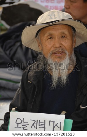 SEOUL SOUTH KOREA APRIL 6; Old man protesting again redundancy people by a company on april 6 2013 in Seoul South Korea