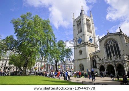 LONDON ENGLAND JUNE 1: Line of tourists waiting to visit Westminster Abbey on june 1 2012 in London England. Westminster Abbey, is a large, mainly Gothic church, in the City of Westminster.
