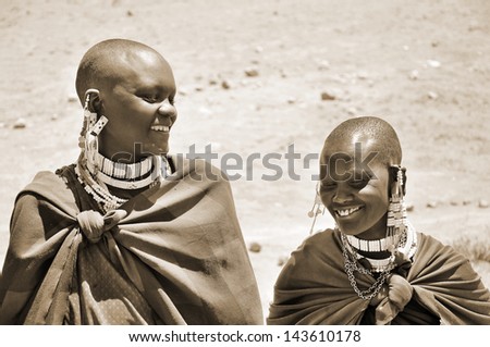 SERENGETI, TANZANIA - NOV 23: Unidentified Masai woman adorned with jewels on November 23, 2011 in the Serengeti, Tanzania. Masai women wear many handmade ornament especially for head and feet.