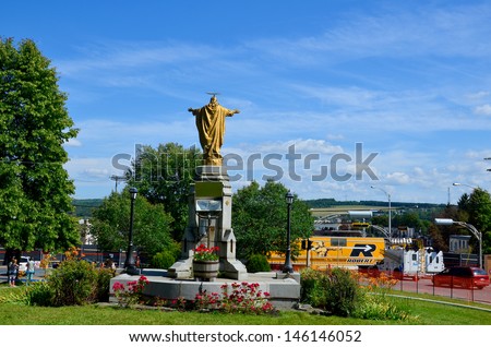 LAC MEGANTIC CANADA JULY 14: Christ statue in front the wost train disaster site in the canadian history on july 14 2013 in Lac Megantic Canada. 50 people was killed in this  humanitarian  disaster.