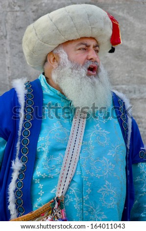 ISTANBUL TURKEY OCTOBER 02: Man dressed like an Ottoman in front the Saint Sofia museum on october 02 2013 in Istanbul Turkey