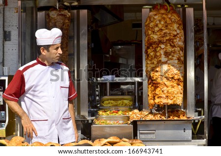 ISTANBUL TURKEY SEPT 28: Young man sells Kebabs for to live in down town Istanbul Turkey on september 28 2013. Street vendors are omnipresent on IstanbulÃÂ¢Ã?Ã?s street.
