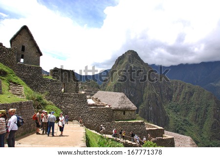 MACHU PICCHU NOVEMBER 24: Tourists walk in Machu Picchu site on November 24 2010 in Machu Picchu. Machu Picchu is a 15th-century Inca site located 2,430 metres (7,970 ft) above sea level