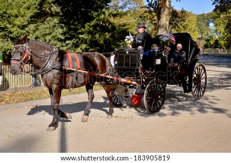 NEW YORK CITY USA OCT 27: Horse carriage rider in Central Park, on ocotber 27 2013 in New York City. Horse-Drawn Carriages are a wonderful way to experience the beauty of the Central Park.