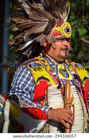 VICTORIA BC CANADA JUNE 24 2015: Native Indian people in traditional costume. First Nations in BC constitute a large number of First Nations governments and peoples in the province of British Columbia