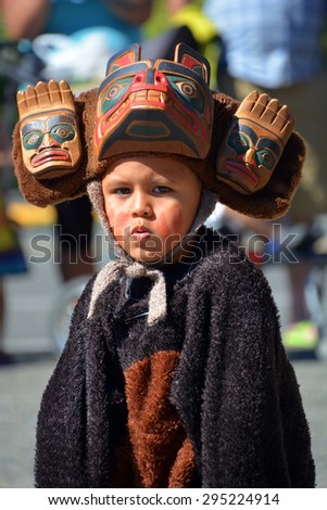 VICTORIA BC CANADA JUNE 24 2015: Native Indian unidentified child in traditional costume. First Nations in BC constitute a large number of First Nations governments and peoples in the province of BC