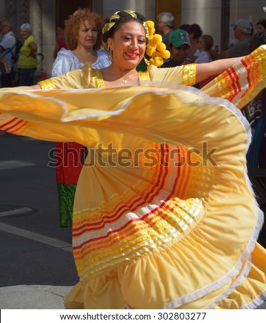 MONTREAL QUEBEC CANADA AUGUST 01 2015: Colombian woman in traditional costume dance La Pollera Colora most famous female skirts with bright colors in the street of Montreal.