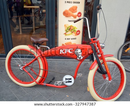 AMSTERDAM NETHERLANDS 10 03 2015: Bicycle in front KFC restaurant.  It is the world\'s second largest restaurant chain (as measured by sales) after McDonald\'s.