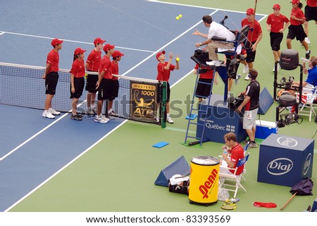 MONTREAL,CANADA - AUGUST 9: Montreal\'s balls boys on court of Montreal Rogers Cup August 9, 2011 in Montreal, Canada. Ball boys were first introduced at Wimbledon in 1920.