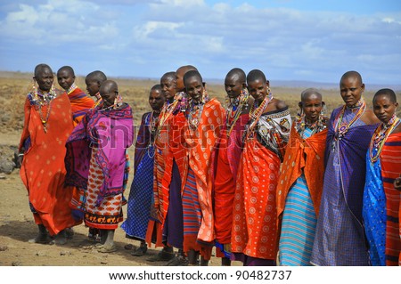 AMBOSELI, KENYA - OCT 13: Group of unidentified African men from Masai tribe prepare to show a traditional Jump dance on Oct 13, 2011 in Masai Mara, Kenya. They are nomadic and live in small villages.
