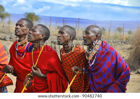 AMBOSELI, KENYA - OCT 13: Group of unidentified African men from Masai tribe prepare to show a traditional Jump dance on Oct 13, 2011 in Masai Mara, Kenya. They are nomadic and live in small villages.