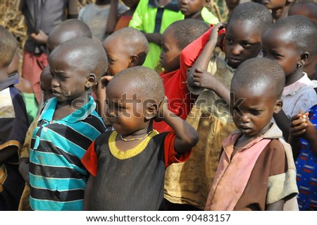AMBOSELI, KENYA - OCT 13: Young unidentified African children from Masai tribe living in house made with cow dung on Oct 13, 2011 in Masai Mara, Kenya.