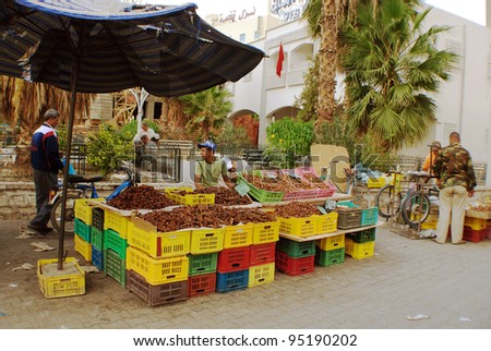 DOUZ - TUNISIA OCTBER 14: Street vendors stand by date fruit stall  on October 14 2007. The market is frequently visited by locals and tourists.