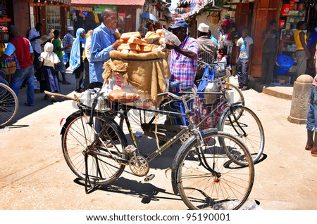 ZANZIBAR - TANZANIA NOV. 24: An unidentified street seller sells fresh bread in Zanzibar, Tanzania on Nov 24, 2011. According to UNICEF, gross national income (GNI) for Tanzania in 2007 is USD$ 720