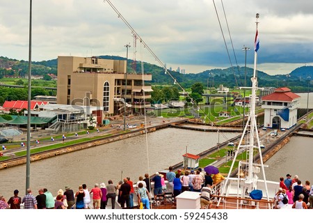 PANAMA CANAL-NOV 8: Passengers on cruse ship watch as ship moves through Panama canal on November 8, 2009 in Panama. Many ships move tourist and cargo through this canal every day of the year.
