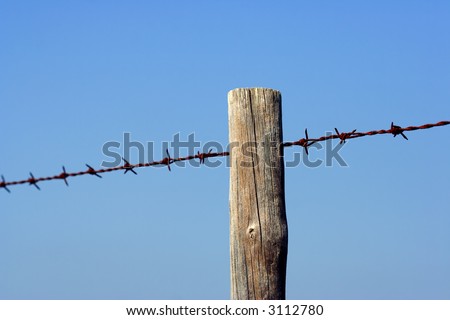 Old fence post and barbed wire