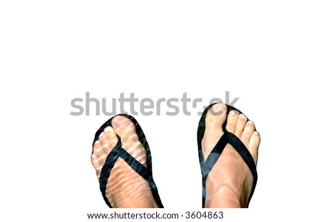 Woman\'s feet with a pair of flip flops cooling in water