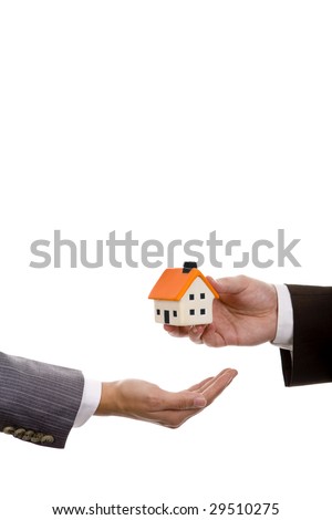 hand holdinh a small house - real state house credit concept