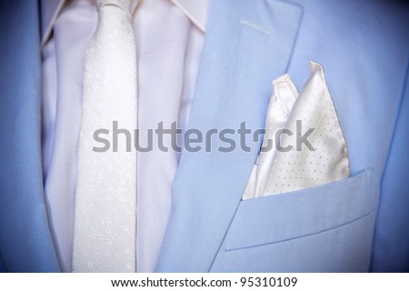 Blue elegant stylish jacket with white shirt and handkerchief in the pocket