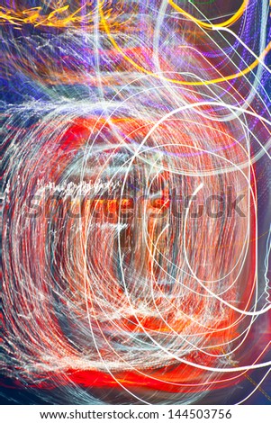 Abstract festive background - bright red, white, blue, yellow twisted lights and lines