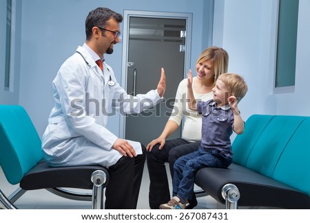 Mother and her son at the hospital talking to a doctor