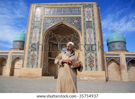 exotic old man dancing and singing in front of an old mosque