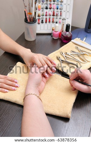 hands painting fingernails with a brush