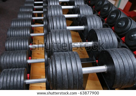 row of dumbell weights in gym room. for lifting or fitness.