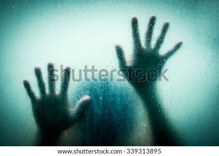 The shadow hands of human behind the glass
