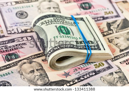 Stack of one hundred dollar bills row on money background