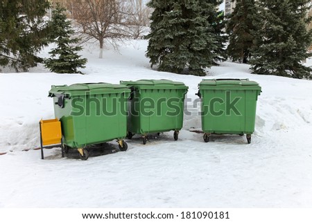 Green recycling containers in the winter park