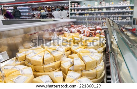 SAMARA, RUSSIA - SEPTEMBER 27, 2014: Showcase with cheese ready to sale in supermarket Magnit. Russia\'s largest retailer