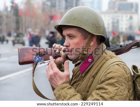 SAMARA, RUSSIA - NOVEMBER 7, 2014: Member of Historical reenactment in Soviet Army uniform after battle. The battle he is reenacting was the Moscow Battle held in 1941.