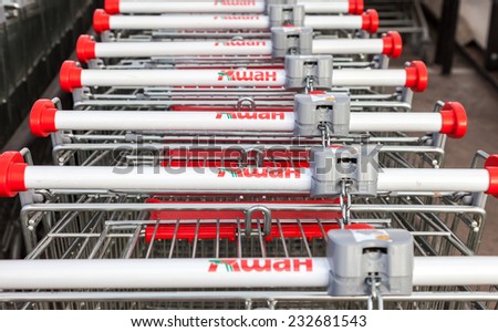 SAMARA, RUSSIA - NOVEMBER 16, 2014: Large empty red shopping cart Auchan store. French distribution network Auchan unites more than 1300 shops