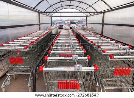 SAMARA, RUSSIA - NOVEMBER 16, 2014: Large empty red shopping cart Auchan store. French distribution network Auchan unites more than 1300 shops