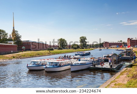 SAINT PETERSBURG, RUSSIA - AUGUST 7, 2014 : River cruise passenger catamarans moored on Neva river near the Peter and Paul fortress in sunny day