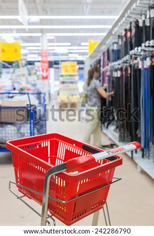 SAMARA, RUSSIA - AUGUST 30, 2014: Empty red shopping cart Auchan store. French distribution network Auchan unites more than 1300 shops