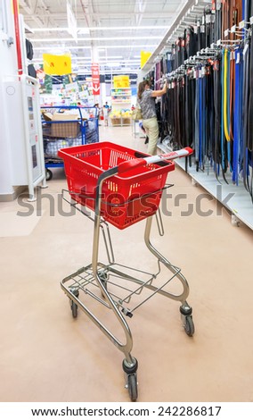 SAMARA, RUSSIA - AUGUST 30, 2014: Empty red shopping cart Auchan store. French distribution network Auchan unites more than 1300 shops