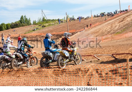 BOROVICHI, RUSSIA - JULY 12, 2014: Motocrossers in the starting line waiting for race to start