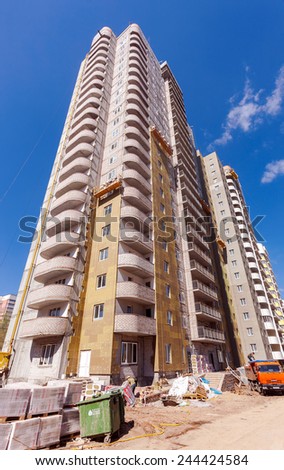 SAMARA, RUSSIA - MAY 8, 2014:Tall apartment buildings under construction  against a blue sky background