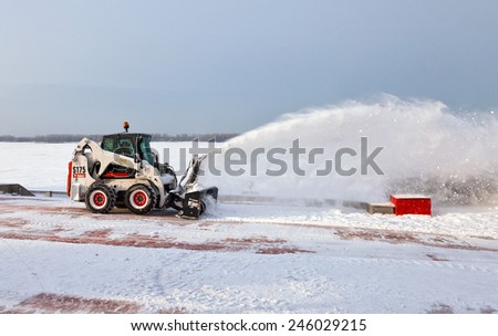 SAMARA, RUSSIA - JANUARY 8, 2014: Snow cleaning pavements and streets of city which are covered in snow during heavy snowfall