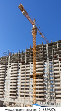 SAMARA, RUSSIA - APRIL 13, 2014:Tall apartment buildings under construction with crane against a blue sky background