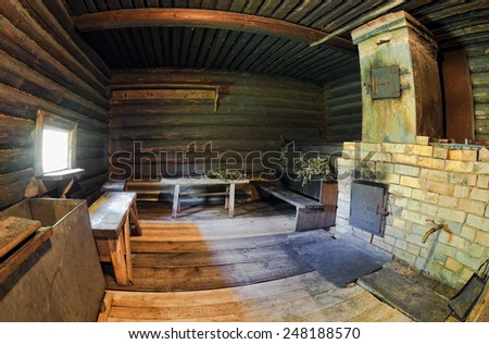 Interior of traditional russian wooden bath with brick oven