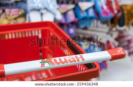SAMARA, RUSSIA - MARCH 8, 2015: Empty red shopping cart Auchan store. French distribution network Auchan unites more than 1300 shops